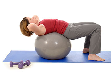 Donna allena schiena su pallone